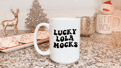 Christmas Mug Mockup- a 15oz mug with a background of Christmas decorations like rain deer, snowman head and Christmas cookies and tree